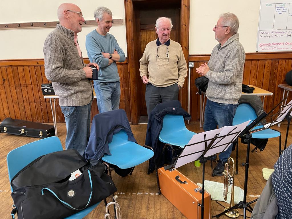 Four brass players take a break.