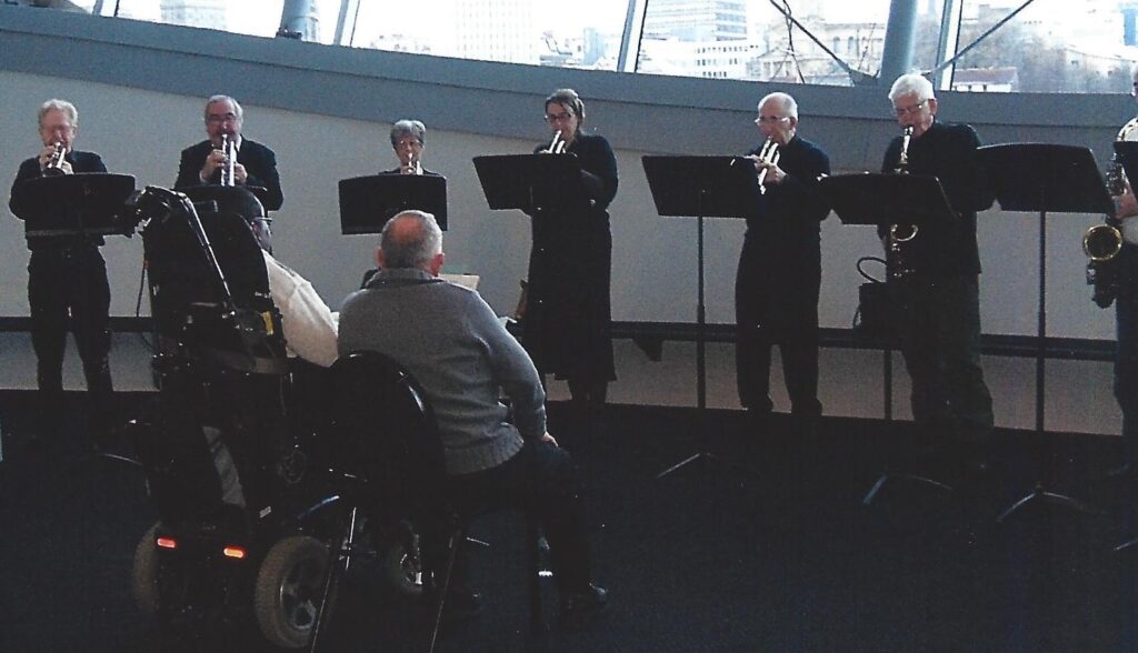 Clarence Adoo with some of the original trumpet and sax players on the concourse of The Sage.