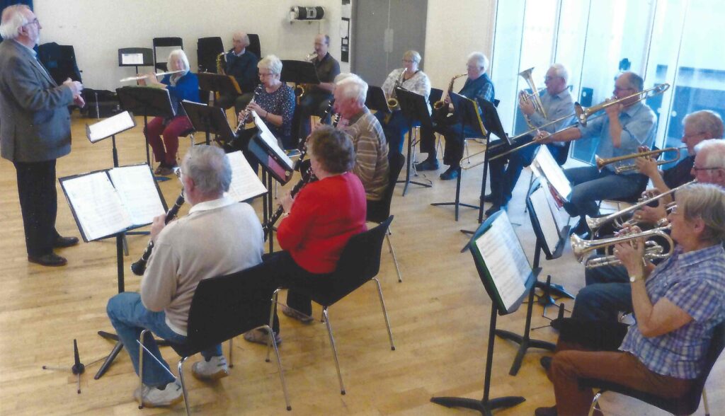 George Parnaby takes rehearsal for fifteen wind players at The Sage.